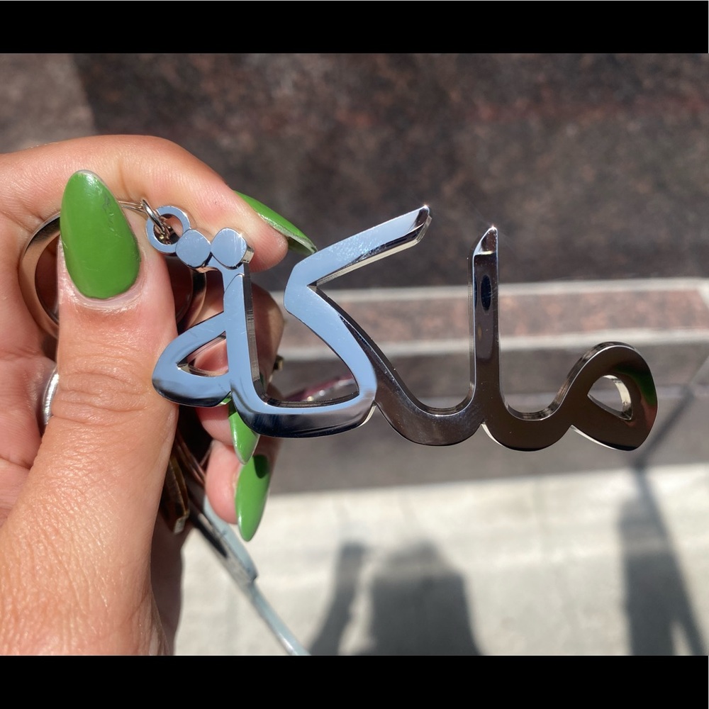 customized keychain with Arabic letters. The logo means Queen (=Malika)